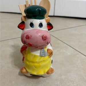 A vintage glazed Ceramic Cow Utensil Holder with Yellow Apron